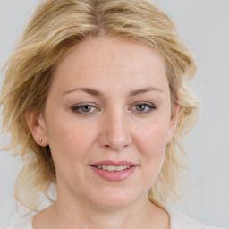 Joyful white young-adult female with medium  brown hair and blue eyes