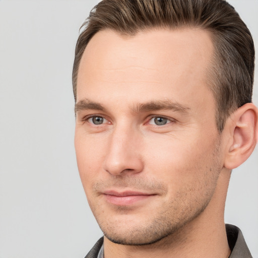 Joyful white young-adult male with short  brown hair and brown eyes