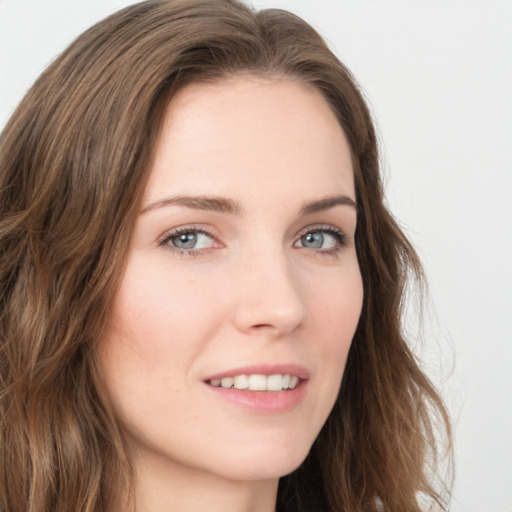 Joyful white young-adult female with long  brown hair and green eyes