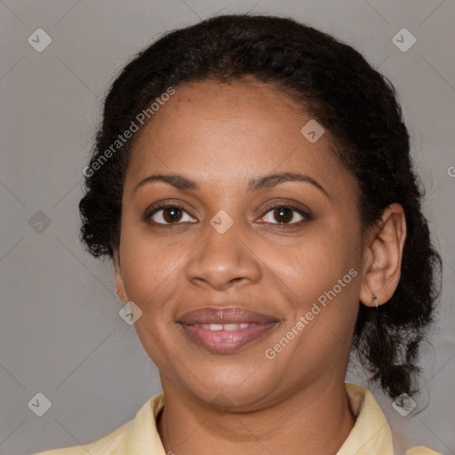 Joyful black adult female with medium  brown hair and brown eyes