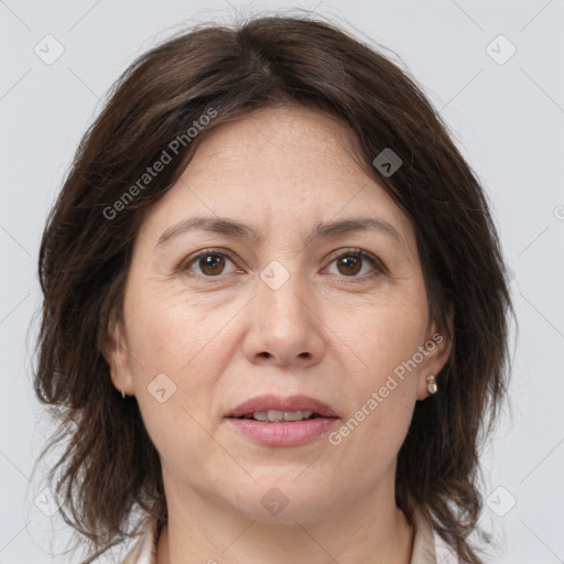 Joyful white adult female with medium  brown hair and brown eyes