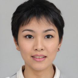 Joyful asian young-adult female with short  brown hair and brown eyes