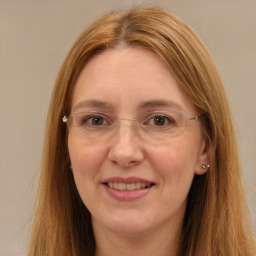 Joyful white adult female with long  brown hair and brown eyes