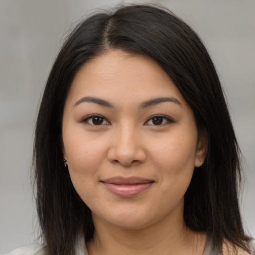 Joyful latino young-adult female with medium  brown hair and brown eyes