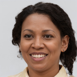 Joyful latino adult female with medium  brown hair and brown eyes