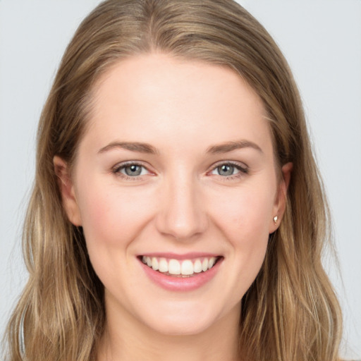 Joyful white young-adult female with long  brown hair and grey eyes