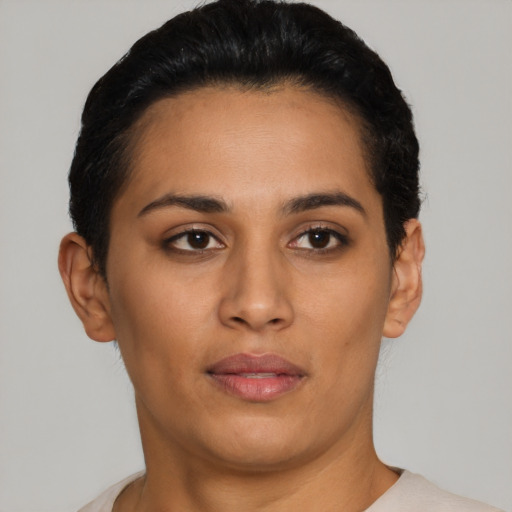 Joyful latino young-adult female with short  black hair and brown eyes