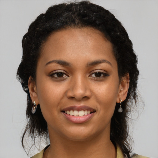 Joyful latino young-adult female with medium  brown hair and brown eyes