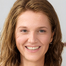 Joyful white young-adult female with long  brown hair and grey eyes