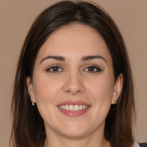 Joyful white young-adult female with long  brown hair and brown eyes