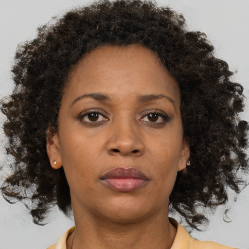 Neutral black adult female with medium  brown hair and brown eyes