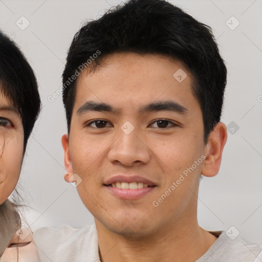 Joyful asian young-adult male with short  black hair and brown eyes