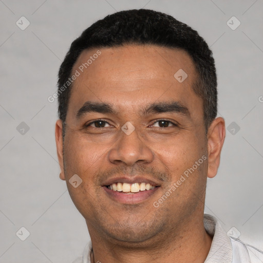 Joyful white young-adult male with short  black hair and brown eyes