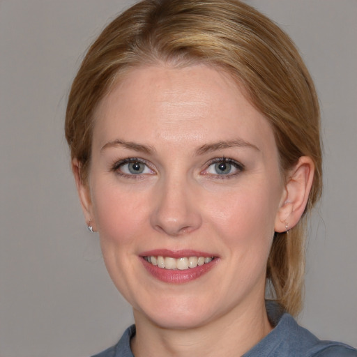 Joyful white young-adult female with medium  brown hair and blue eyes