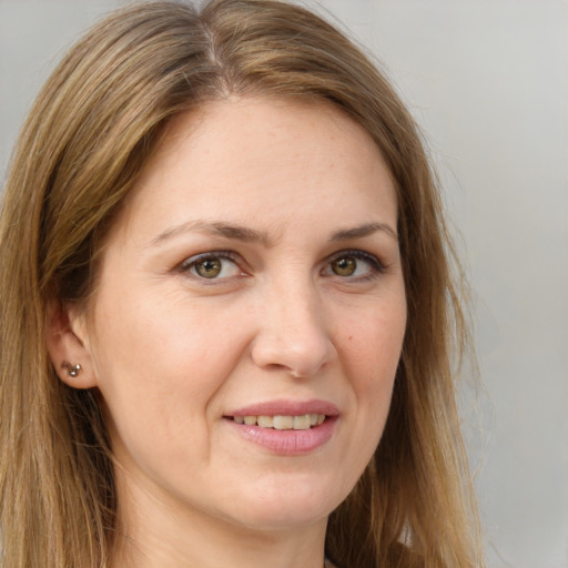 Joyful white adult female with long  brown hair and brown eyes