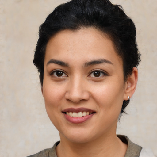 Joyful latino young-adult female with short  brown hair and brown eyes