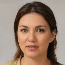 Joyful white young-adult female with medium  brown hair and brown eyes