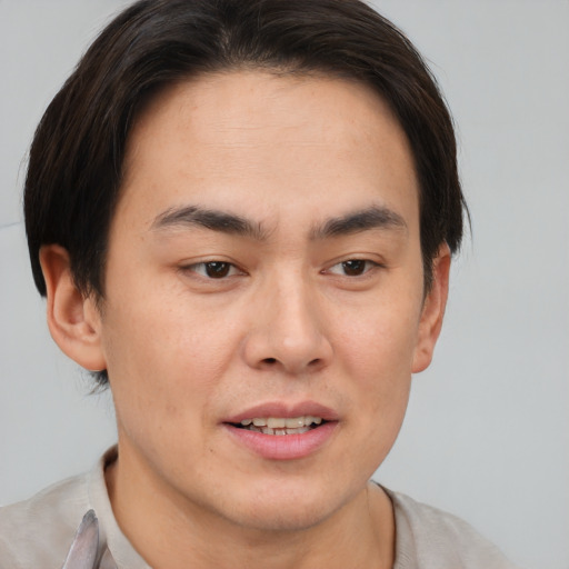 Joyful asian young-adult male with short  brown hair and brown eyes