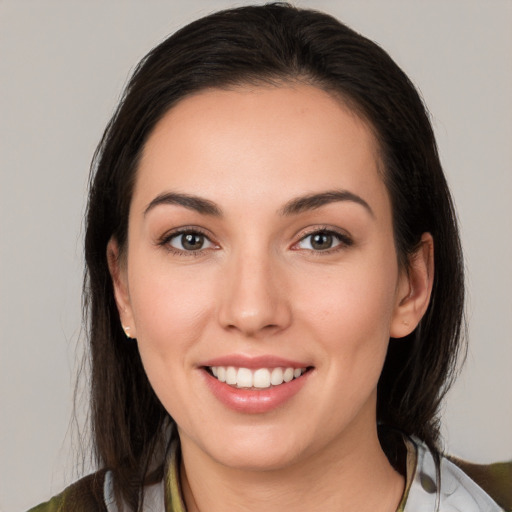 Joyful white young-adult female with medium  brown hair and brown eyes