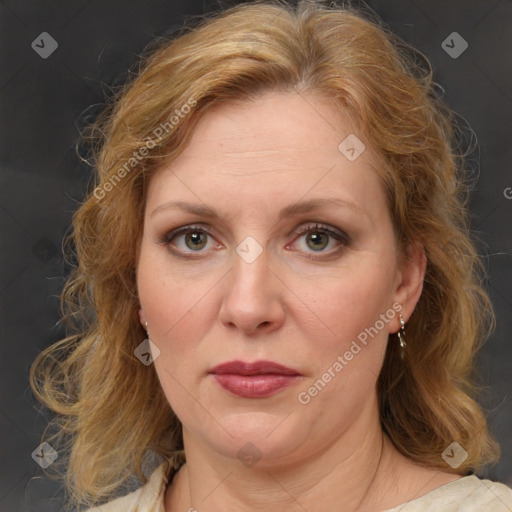 Joyful white adult female with medium  brown hair and blue eyes