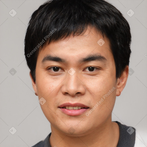 Joyful asian young-adult male with short  black hair and brown eyes