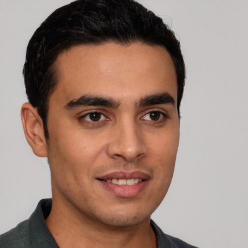 Joyful white young-adult male with short  brown hair and brown eyes