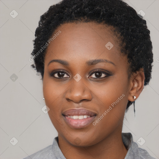 Joyful black young-adult female with short  black hair and brown eyes