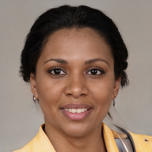 Joyful black young-adult female with medium  brown hair and brown eyes