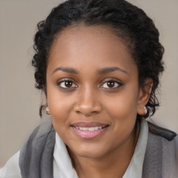 Joyful black young-adult female with long  brown hair and brown eyes