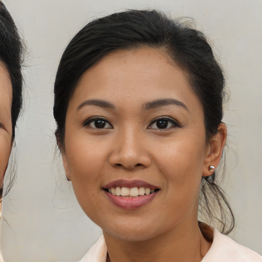 Joyful asian young-adult female with medium  brown hair and brown eyes