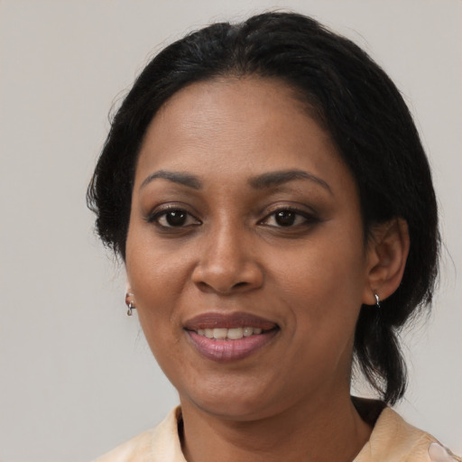 Joyful black adult female with medium  black hair and brown eyes