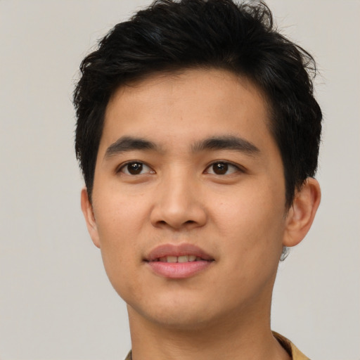Joyful asian young-adult male with short  brown hair and brown eyes