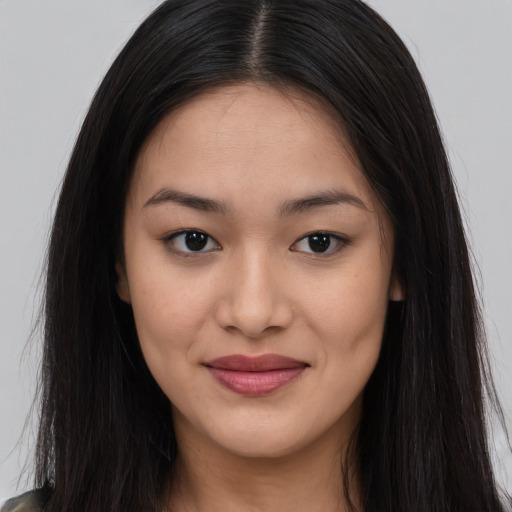 Joyful asian young-adult female with long  brown hair and brown eyes