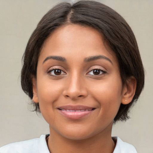 Joyful latino young-adult female with medium  brown hair and brown eyes