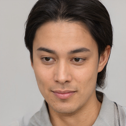 Joyful white young-adult male with medium  brown hair and brown eyes