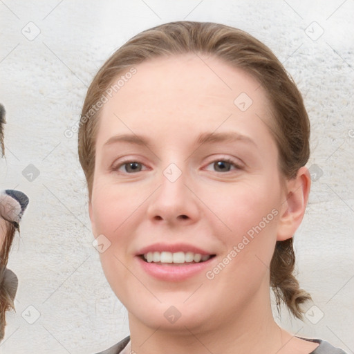 Joyful white young-adult female with medium  brown hair and blue eyes