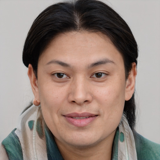 Joyful asian adult female with medium  brown hair and brown eyes