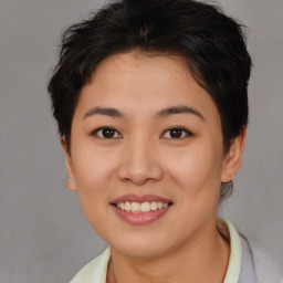 Joyful asian young-adult female with short  brown hair and brown eyes