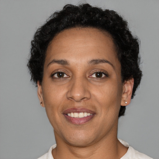 Joyful black adult female with short  brown hair and brown eyes