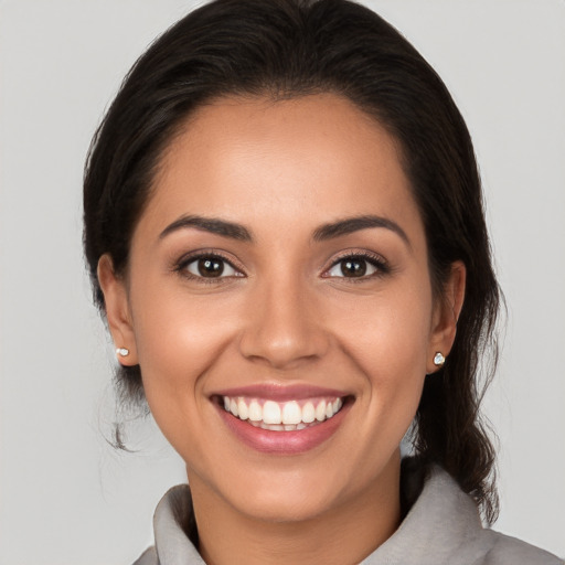 Joyful white young-adult female with medium  brown hair and brown eyes