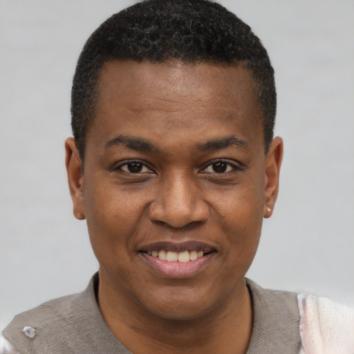 Joyful black young-adult male with short  brown hair and brown eyes