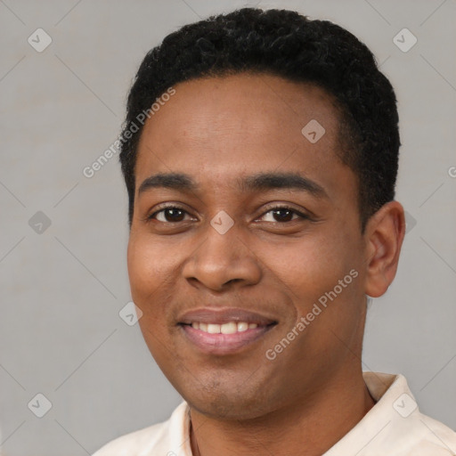 Joyful latino young-adult male with short  black hair and brown eyes