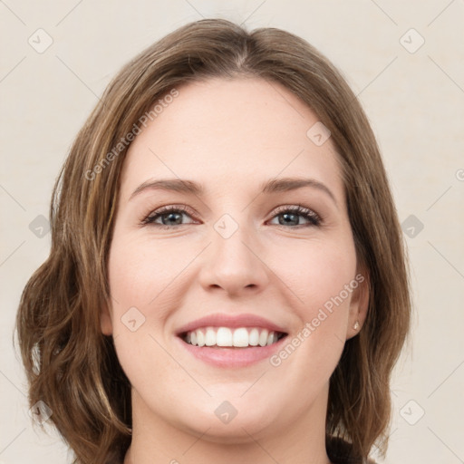 Joyful white young-adult female with medium  brown hair and green eyes