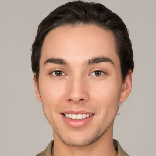 Joyful white young-adult male with short  brown hair and brown eyes