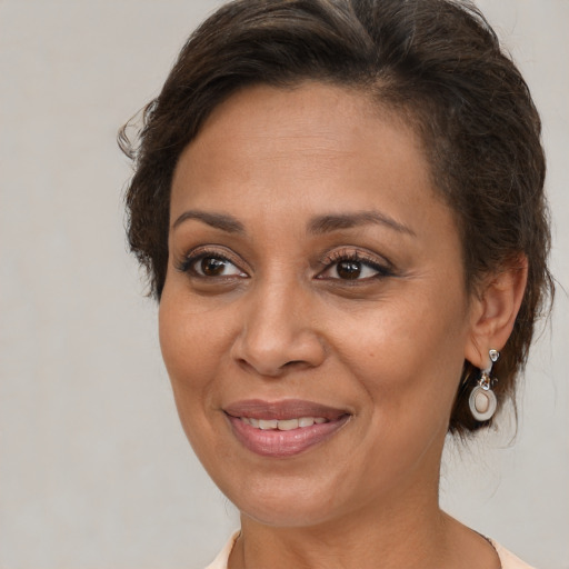 Joyful white adult female with medium  brown hair and brown eyes