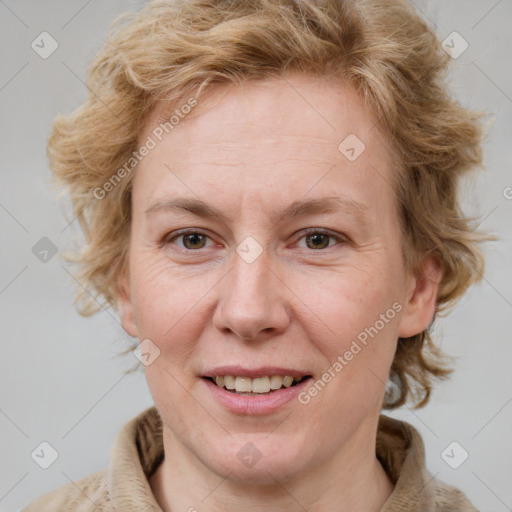 Joyful white adult female with medium  brown hair and blue eyes