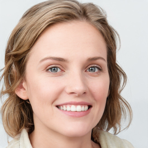 Joyful white young-adult female with medium  brown hair and blue eyes