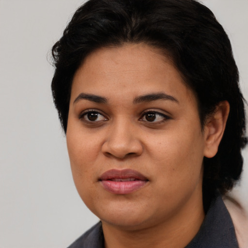 Joyful latino young-adult female with short  black hair and brown eyes