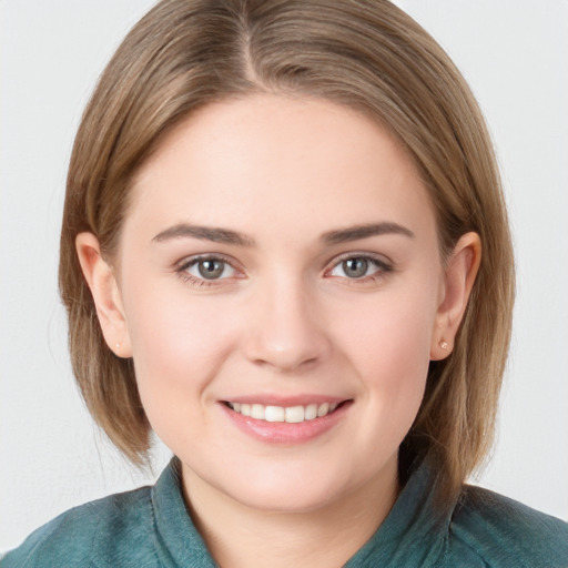 Joyful white young-adult female with medium  brown hair and blue eyes