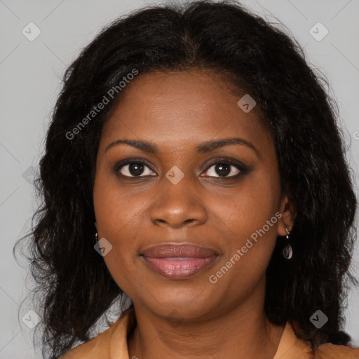 Joyful black young-adult female with long  brown hair and brown eyes